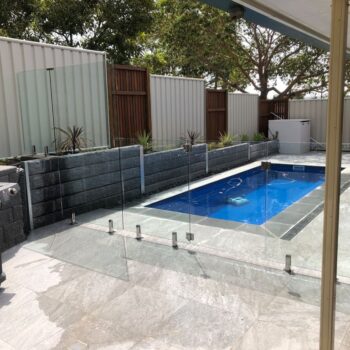 FRAMELESS GLASS FENCING WITH CUSTOM RETAINING WALL PANEL