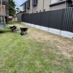 Colorbond on top of concrete sleeper retaining wall (Monument)
