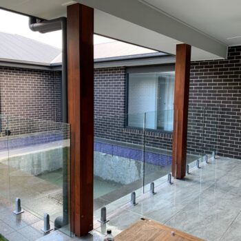 GLASS FENCING WITH ISOLATOR COVERS