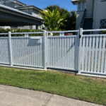 Pearl White Hamptons aluminium slat fencing with single gate