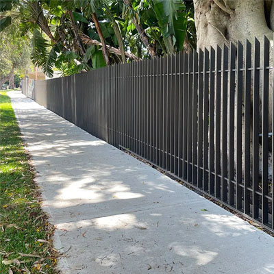 Steel palisade fence installed along public walkway for perimeter security